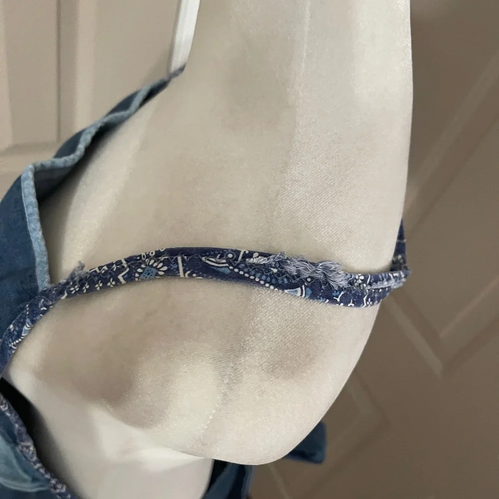 Vintage medium wash light weight ruffled denim apron with embroidered pocket.